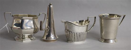 A 1930s stylish silver mug, a silver sugar bowl, a silver cream jug and a silver candle snuffer.